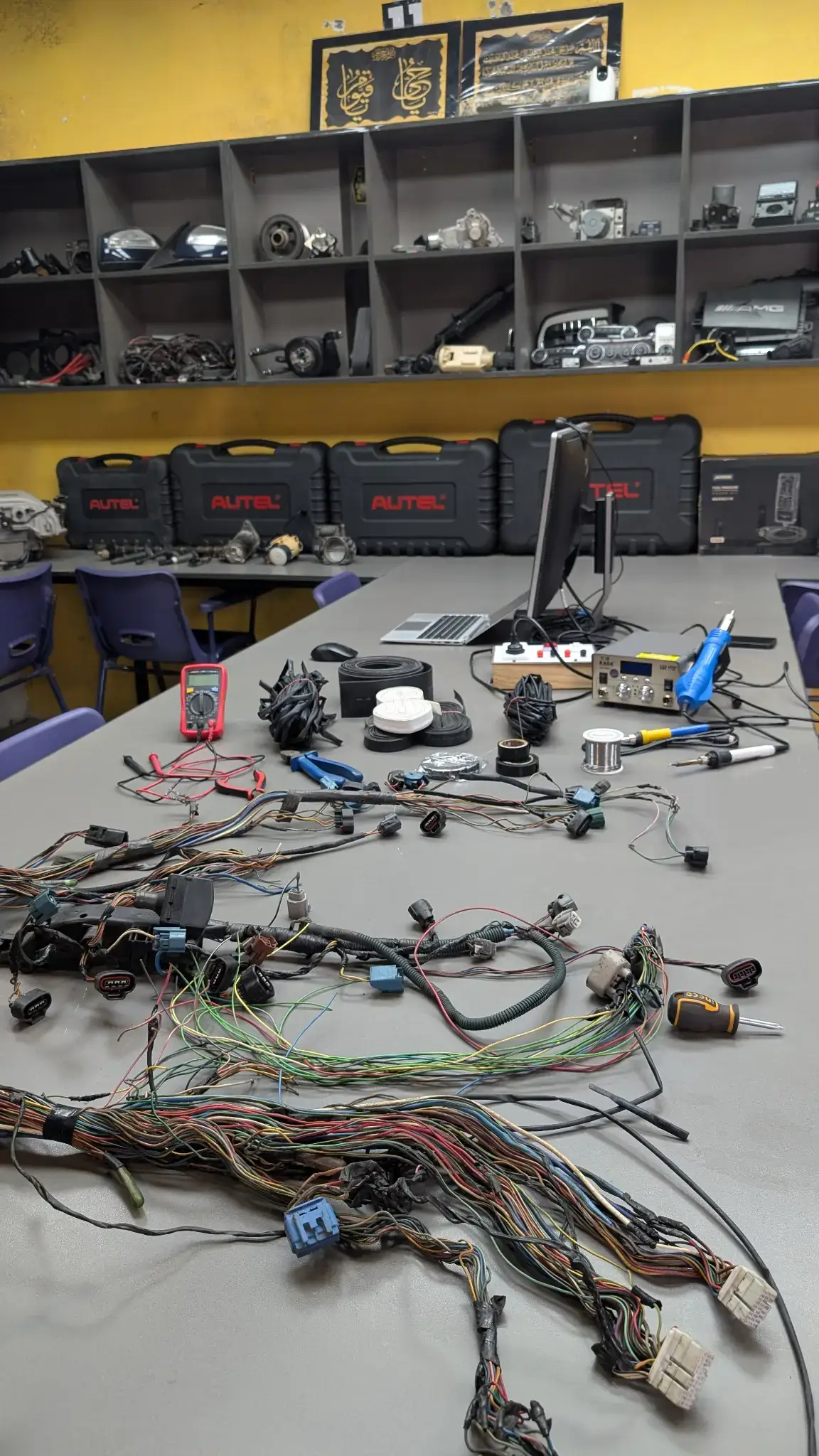Actual HPR Academy classroom with wiring harnesses and automotive electronics tools